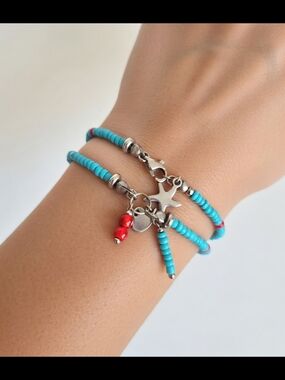 Two-strand bracelet with glass beads and stainless steel charms.